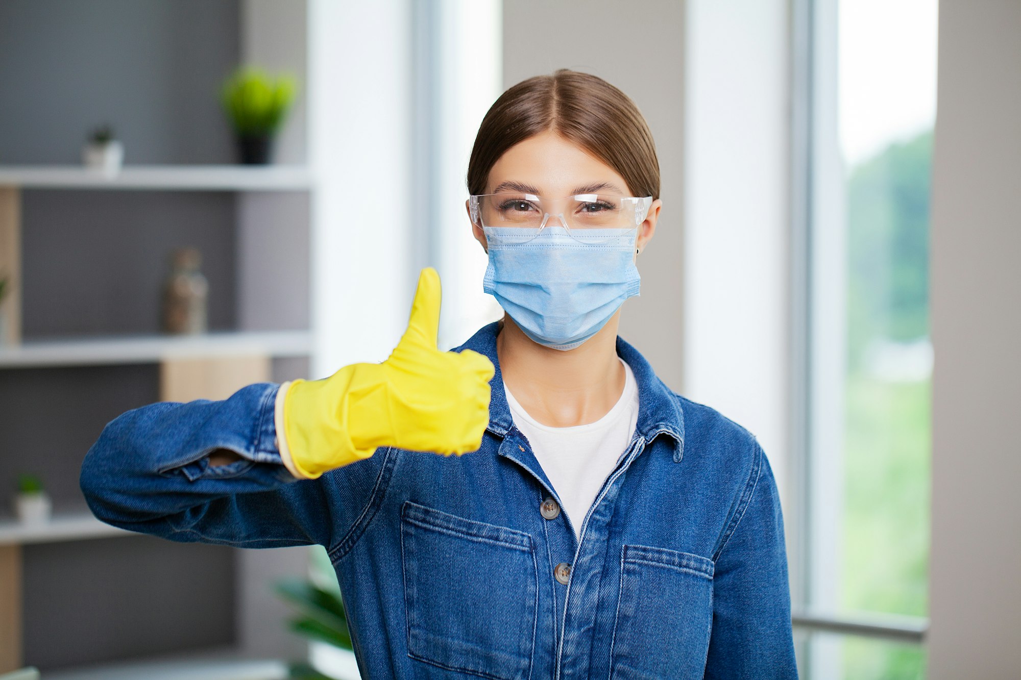 Portrait of happy female cleaner with cleaning equipment in office Portrait of happy female cleaner with cleaning equipment in office